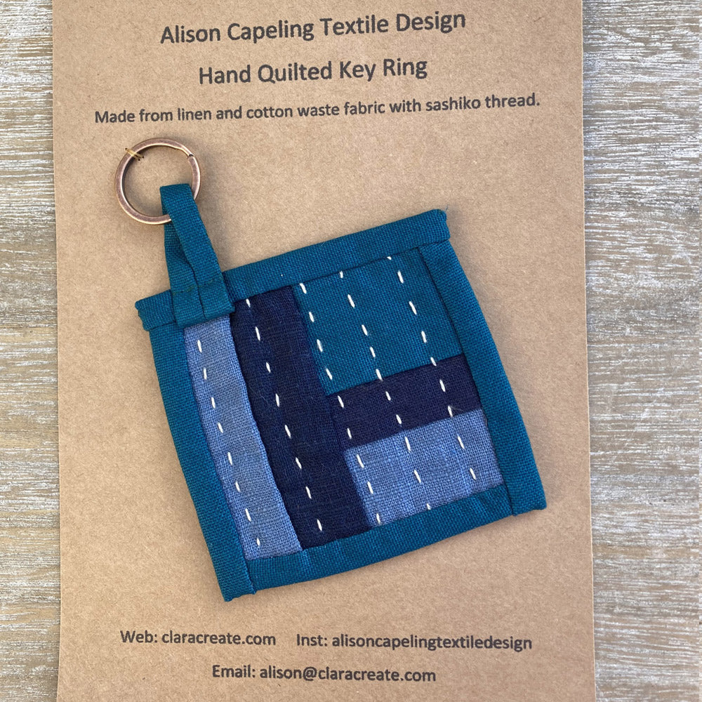 Hand quilted key ring made from navy, blue and turquoise linen and cotton.