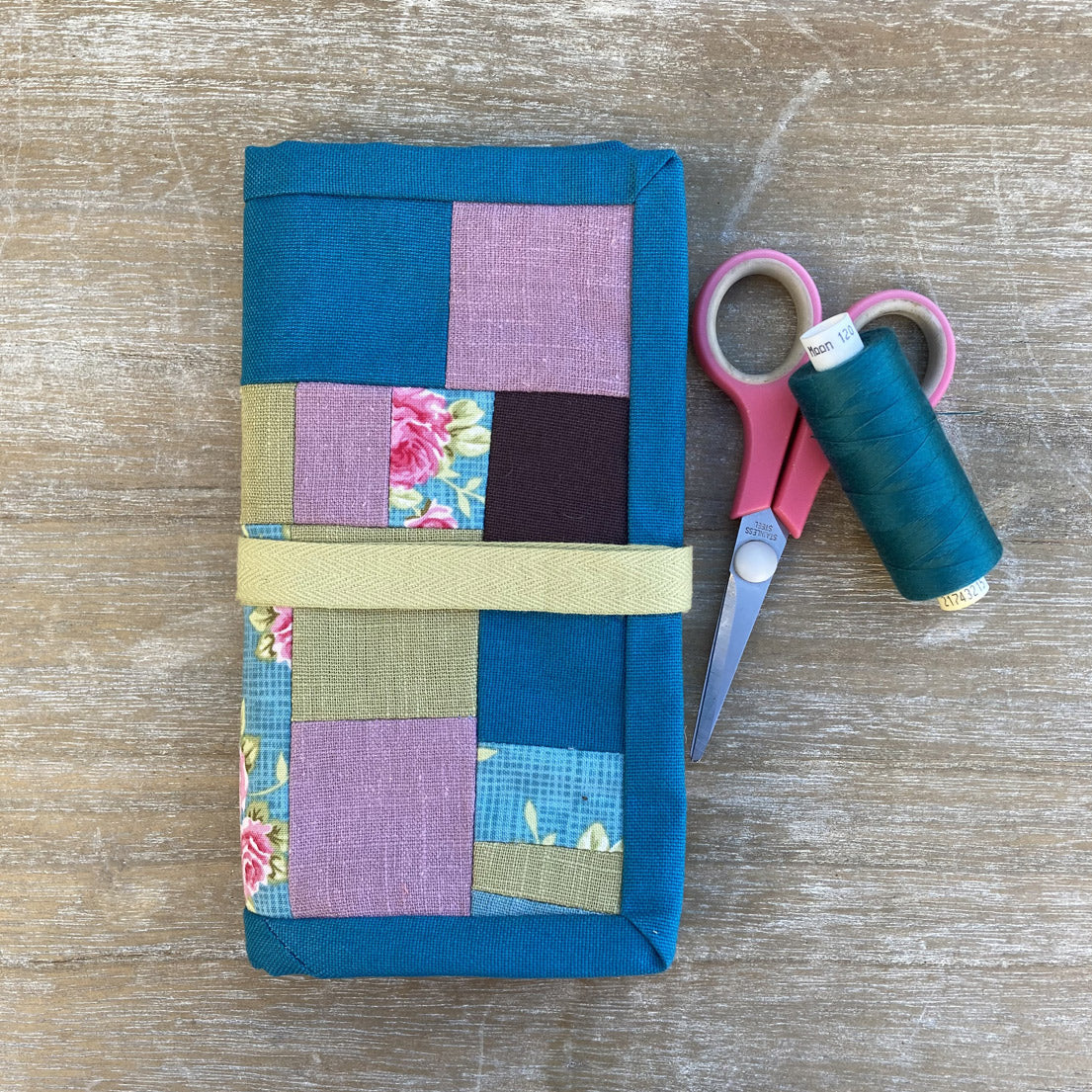 Handmade quilted sewing case for crafting accessories.