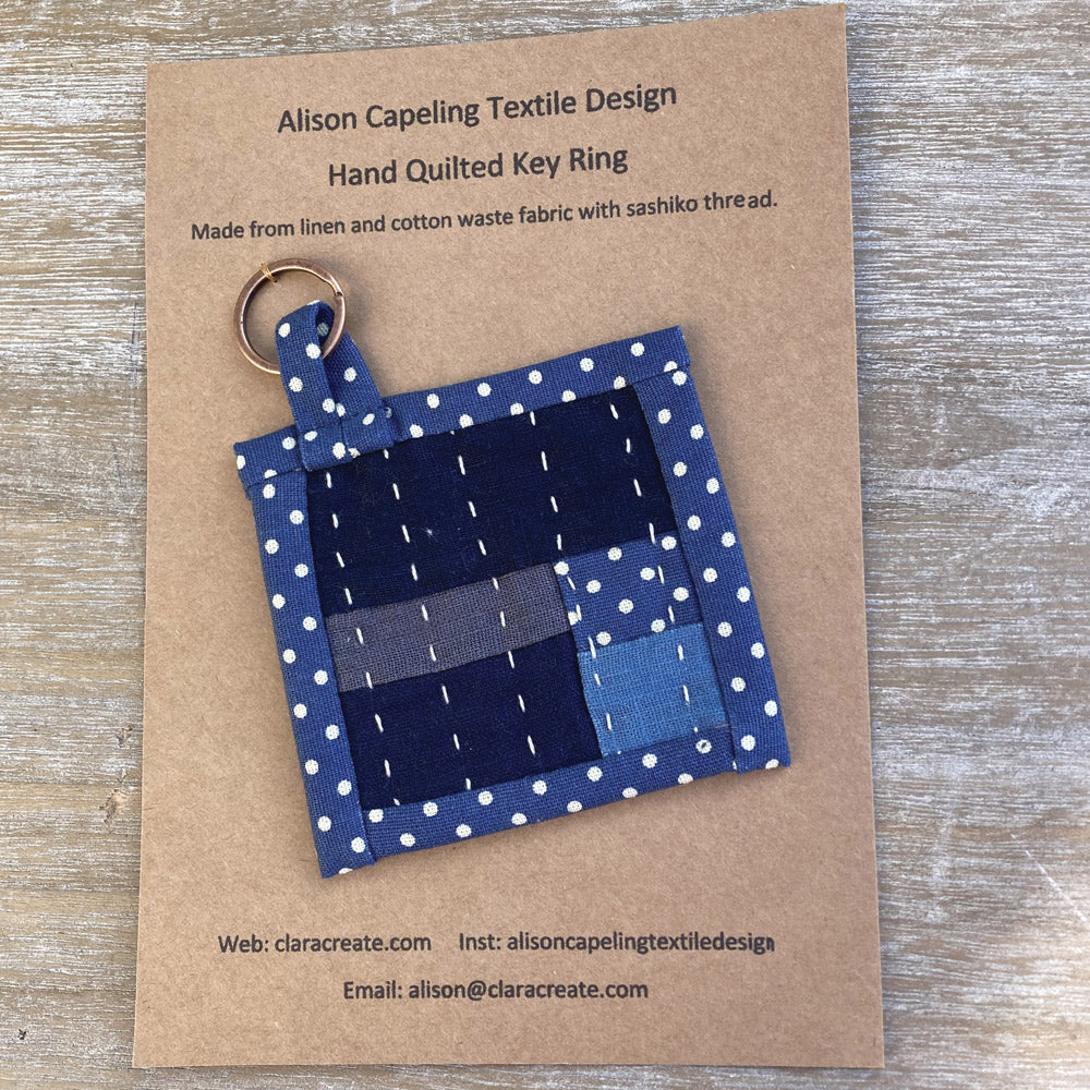 Hand quilted textile key ring. Made from blue spotty cotton and navy linen fabric. Hand stitch sashiko thread.