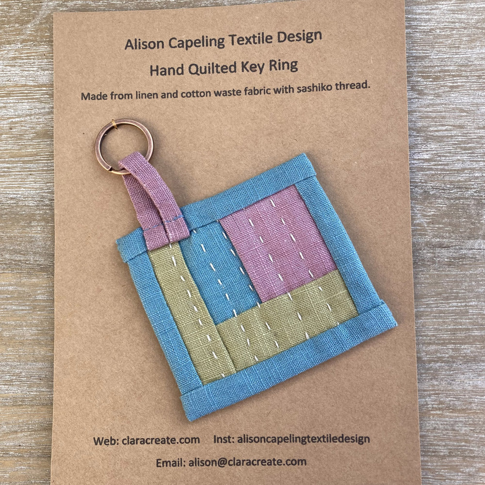 Hand quilted key fob in blue, pink and green linen. hand stitch in sashiko thread.
