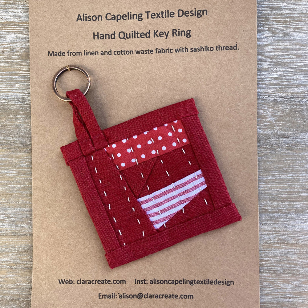 Quilted key fob. Hand stitched in linen and cotton fabric and finished with hand sewn sashiko thread. Made from waste fabrics.