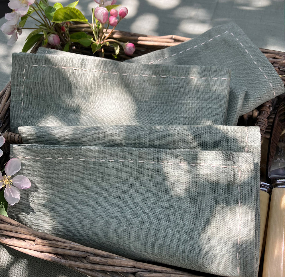 Light sage green napkins with hand slow stitch in natural fabric