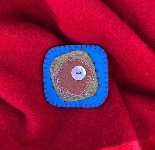 Turquoise felt hand stitched brooch.