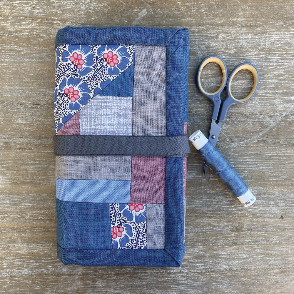 Roll up sewing case, individually quilted in blues and grey natural patchwork.