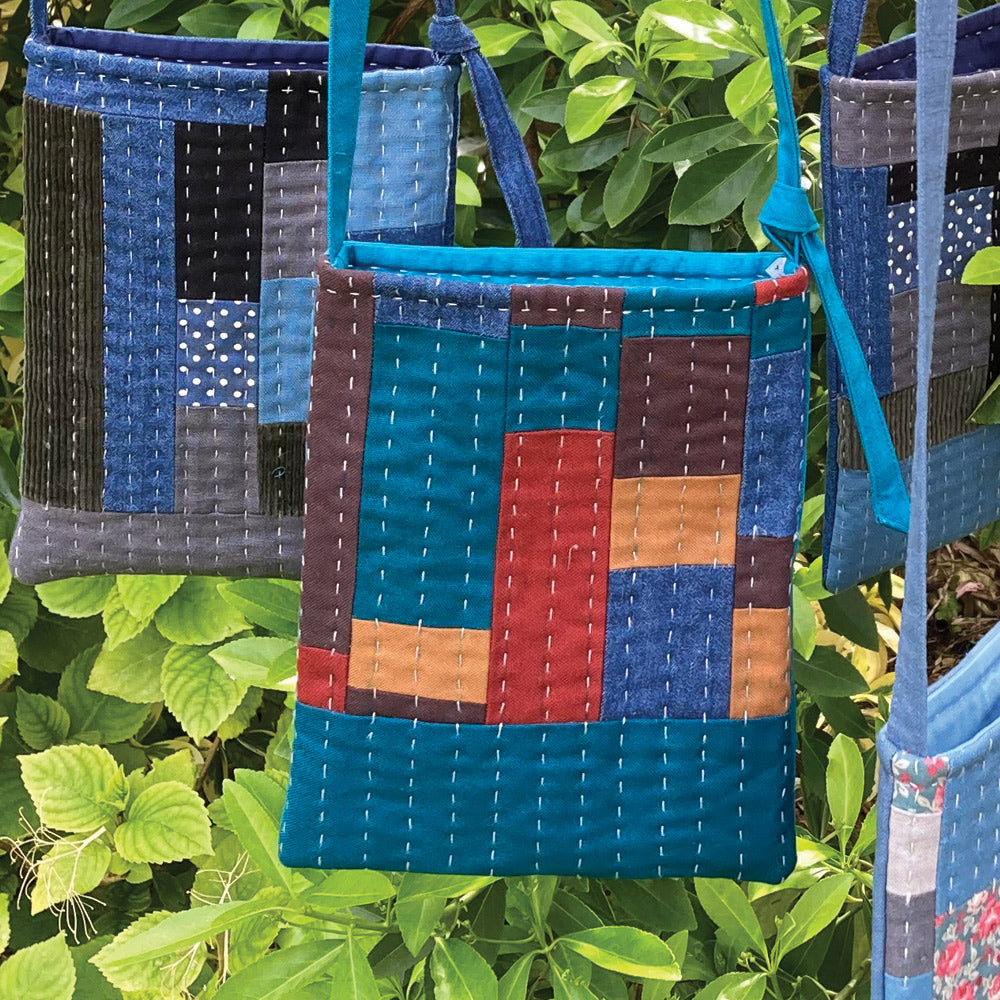 Handmade patchwork slow stitch shoulder bag. Made in cotton and denim.