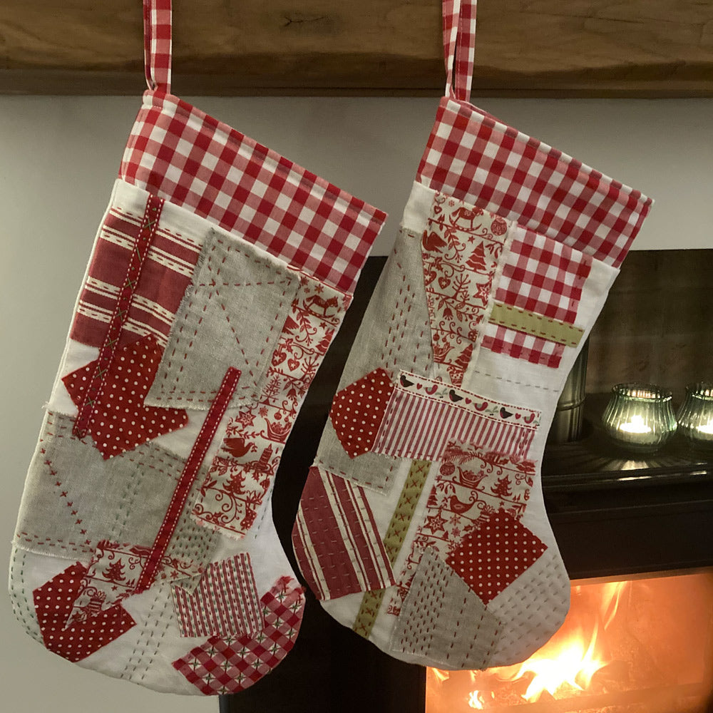Quilted and handstitched Christmas stocking in red, white and natural fabric and ribbons. Individial one off piece.