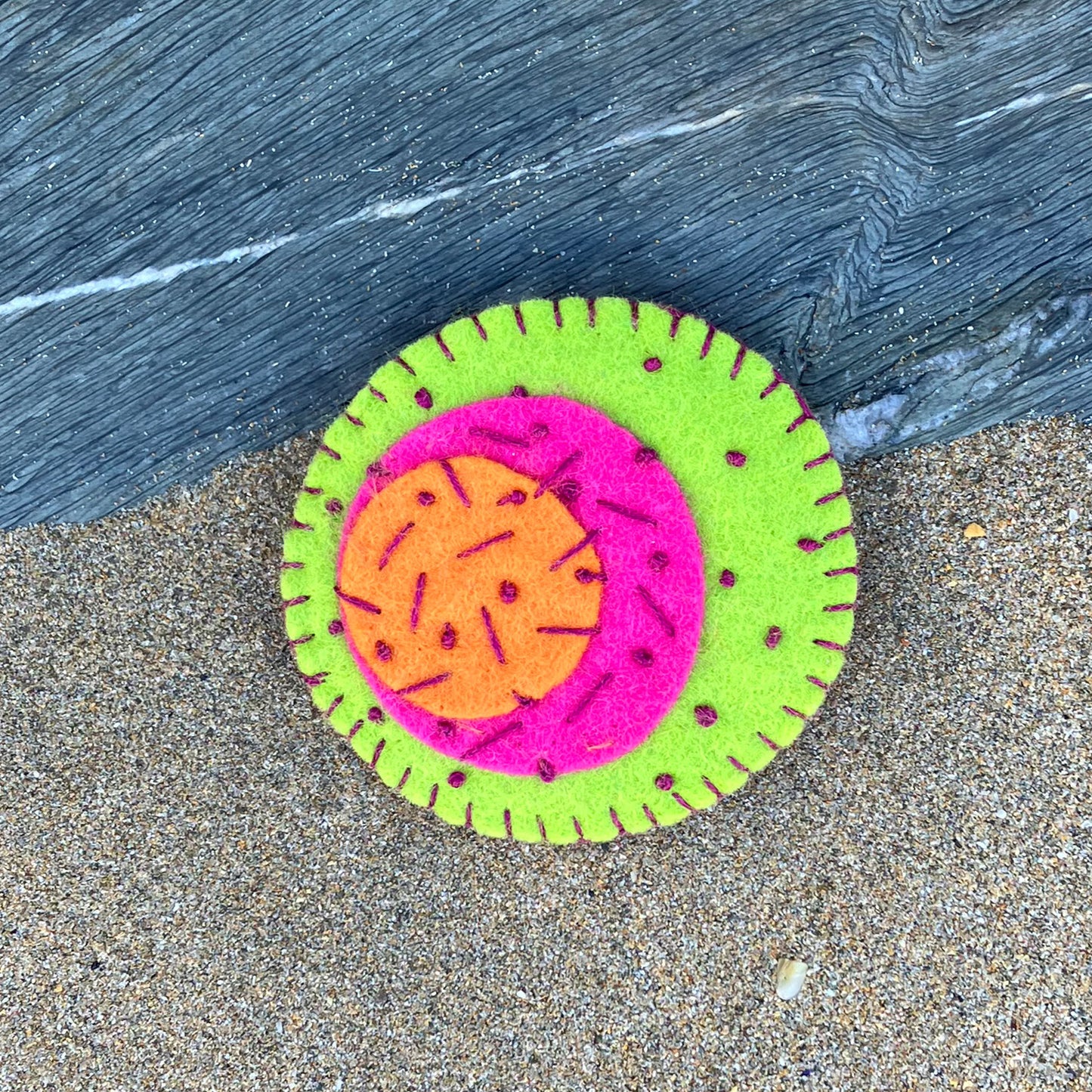Hand stitches brooch in orange, pink and green natural felt.