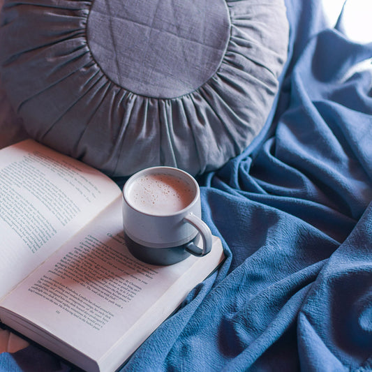 Round Linen Cushion in Soft Grey with cup of coffee