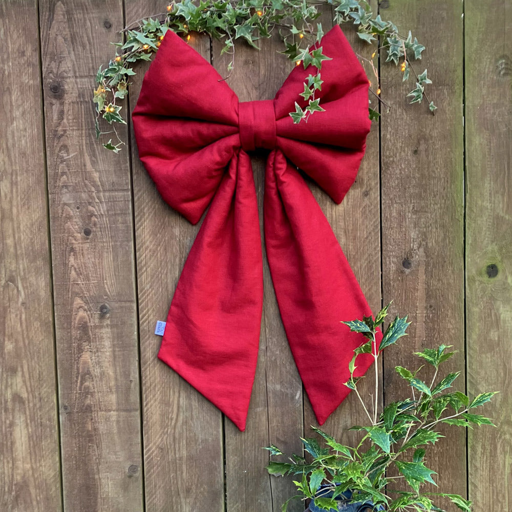 This sumptuous extra-large Christmas Bow in dark red natural fabric.