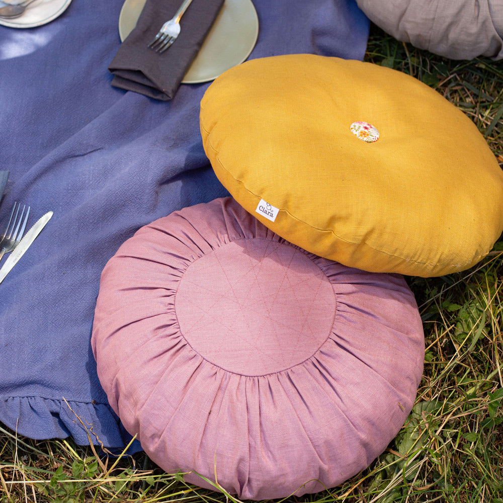 Round Linen Cushion in Heather Pink at a picnic
