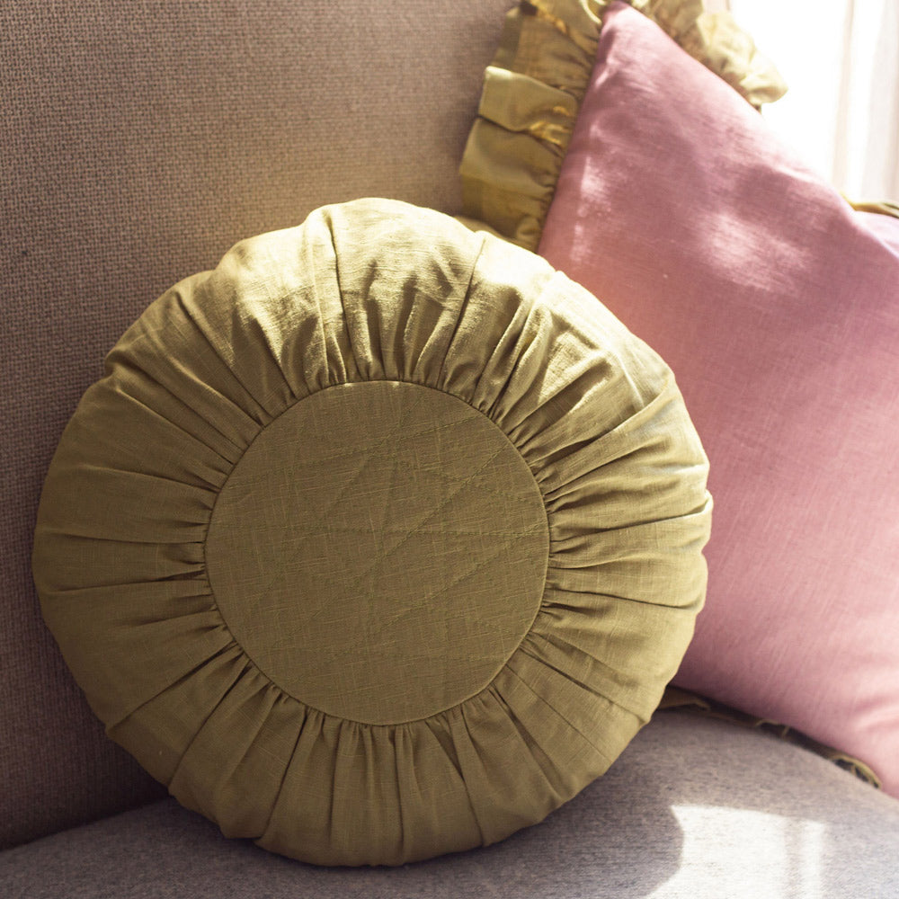 Round Linen Cushion in Green on sofa